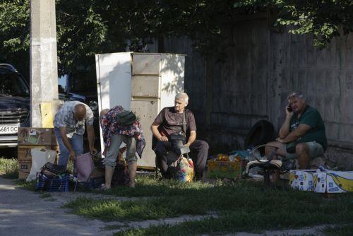 epa13141167 Sellers sit at the site of a Russian missile strike on a market in Kyiv, Ukraine, 30 July 2026, amid the Russian invasion.  At least eight people died, and dozens of people were injured after an overnight massive combined Russian attack in Ukraine, according to the State Emergency Service. Russia launched at least 70 missiles of different types...