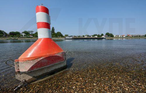 epa13141329 A buoy used to mark the waterway on the Rhine river is sitting on dry land in Speyer, Germany, 30 July 2026. Due to a severe heatwave and prolonged dry weather, water levels on the Rhine River in Germany have plunged. The German Weather Service (DWD) expects the heat wave to peak in the coming days, with temperatures between 34 and 38 degrees...