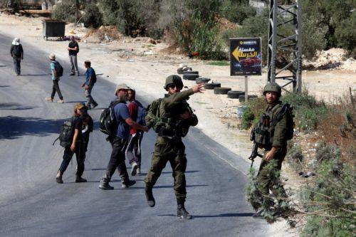 epa13143503 Israeli soldiers throw a sound grenade at Palestinians while guarding Israeli settlers entering the village of Sara, near the West Bank city of Nablus, 31 July 2026. According to the Palestinian news agency WAFA, a Palestinian man was injured when Israeli soldiers fired live bullets at a group of Palestinians in the Al Jouned area, as dozens of...