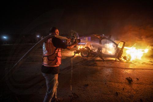 epa13149104 Palestinian Civil Defense personnel extinguish a fire in a destroyed car following an Israeli airstrike on Al-Rashid Road next to the beach in southern Gaza City, 03 August 2026. According to the Gaza Health Ministry,  two Palestinians were killed in the strike.  EPA/MOHAMMED SABER