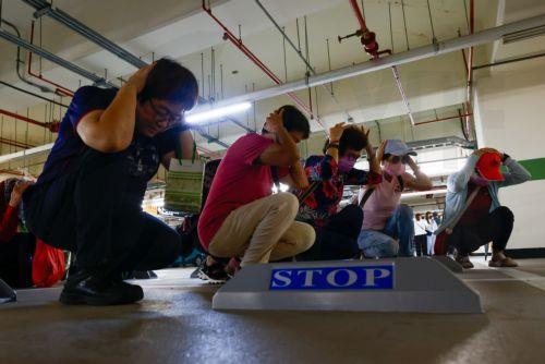 epa13158703 People take shelter during the Wan-An Air raid drill or Urban Resilience (Air Defense) Drill as part of the annual Han Kuang military exercises in Taichung, Taiwan, 10 August 2026. Taiwan’s Han Kuang exercises test combat readiness against a potential Chinese invasion.  EPA/RITCHIE B. TONGO