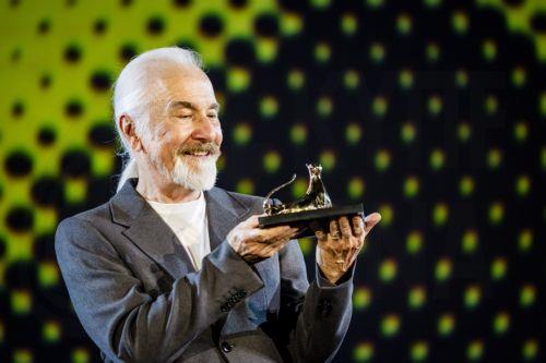 epa13165118 US makeup effects artist Rick Baker, winner of the 'Vision Award,' celebrates on the Piazza Grande stage during the 79th Locarno Film Festival in Locarno, Switzerland, 12 August 2026.  EPA/JEAN-CHRISTOPHE BOTT