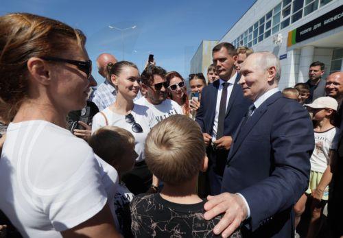 epa13166359 Russian President Vladimir Putin (R) meets local residents on Iturup Island, Sakhalin region, Russia, 13 August 2026.  EPA/GAVRIIL GRIGOROV / SPUTNIK / KREMLIN POOL MANDATORY CREDIT