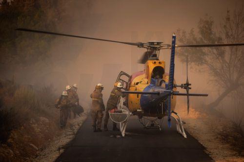 epa13176357 A helicopter is prepared to fight the flames of a forest fire in Vilarinho da Castanheira, Portugal, 17 August 2026. The fire started in Torre de Moncorvo and spread to the municipality of Carrazeda de Ansiaes.  EPA/PEDRO SARMENTO COSTA
