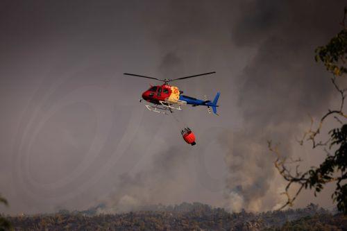epa13176358 A helicopter fights the flames of a forest fire in Vilarinho da Castanheira, Portugal, 17 August 2026. The fire started in Torre de Moncorvo and spread to the municipality of Carrazeda de Ansiaes.  EPA/PEDRO SARMENTO COSTA