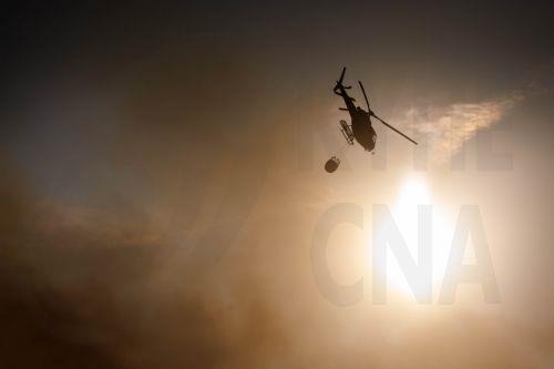 epa13176359 A helicopter fights the flames of a forest fire in Vilarinho da Castanheira, Portugal, 17 August 2026. The fire started in Torre de Moncorvo and spread to the municipality of Carrazeda de Ansiaes.  EPA/PEDRO SARMENTO COSTA