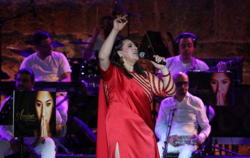 epa13176462 Tunisian singer Amina Fakhet performs during the 60th edition of the Carthage International Festival at the Roman Theatre of Carthage in Tunis, Tunisia, 17 August 2026. The festival runs from 16 July to 19 August 2026.  EPA/MOHAMED MESSARA