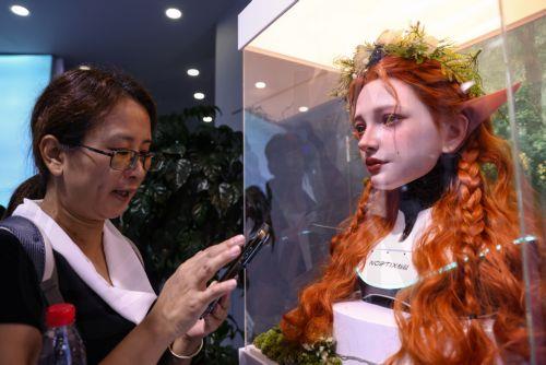 epaselect epa13180295 A visitor takes a picture of an embodied robot head  at the Noetix Robotics stand during the 2026 World Robot Conference in Beijing, China, 20 August 2026. The WRC event runs from 19 to 23 August.  EPA/WU HAO