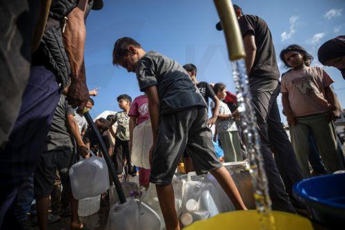 epa13180442 Displaced Palestinians line up to collect drinking water at a displacement camp in central Gaza City, 20 August 2026. Gaza's municipalities and water authorities have warned of an imminent collapse of drinking-water and sewage systems, threatening more than two million people with severe water shortages and the spread of disease. Water...