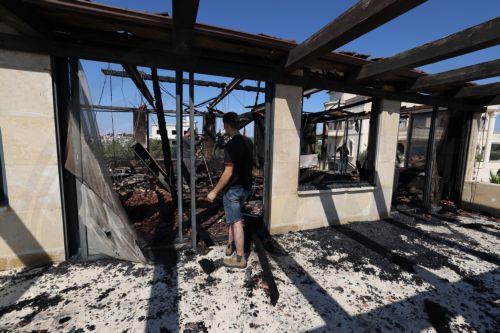 epa13186042 Palestinians inspect the damage to their home in the West Bank village of Usarin, south of Nablus, 23 August 2026. According to the Palestinian Wafa news agency, Israeli settlers set fire to a residential building and partially burned a Palestinian-owned vehicle and scrawled racist slogans in the village of Usarin, south of Nablus, late last...