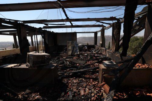 epa13186046 Palestinians inspect the damage to their home in the West Bank village of Usarin, south of Nablus, 23 August 2026. According to the Palestinian Wafa news agency, Israeli settlers set fire to a residential building and partially burned a Palestinian-owned vehicle and scrawled racist slogans in the village of Usarin, south of Nablus, late last...