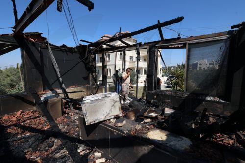 epa13186048 Palestinians inspect the damage to their home in the West Bank village of Usarin, south of Nablus, 23 August 2026. According to the Palestinian Wafa news agency, Israeli settlers set fire to a residential building and partially burned a Palestinian-owned vehicle and scrawled racist slogans in the village of Usarin, south of Nablus, late last...