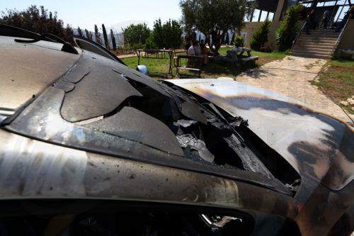 epa13186049 Palestinians inspect a damaged vehicle in the West Bank village of Usarin, south of Nablus, 23 August 2026. According to the Palestinian Wafa news agency, Israeli settlers set fire to a residential building and partially burned a Palestinian-owned vehicle and scrawled racist slogans in the village of Usarin, south of Nablus, late last night. ...