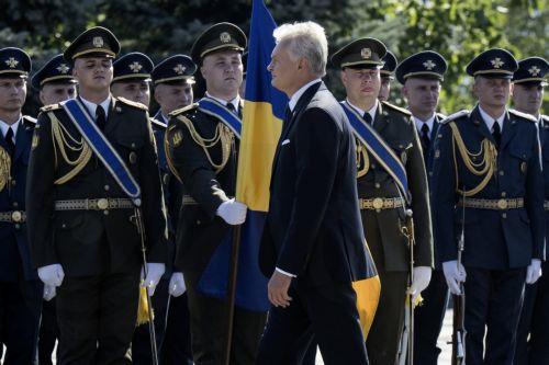 epa13186122 Lithuania's President Gitanas Nauseda attends the ceremony of the National Flag raising in Kyiv, Ukraine, 23 August 2026, amid the ongoing Russian invasion. Ukraine celebrates the National Flag Day on 23 August every year.  EPA/Maxym Marusenko