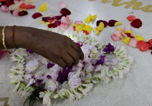 epa13191745 A visitor offers floral tribute after a mass prayer celebrating the 116th birth anniversary of Mother Teresa at the Mother House in Kolkata, India, 26 August 2026. Mother Teresa, born Agnes Gonxha Bojaxhiu on 26 August 1910 to Albanian parents in Skopje, began serving the poor in Calcutta in 1948 and was awarded the Nobel Peace Prize in 1979. ...