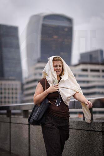 epa13194108 A commuter tries to shelter from the rain during heavy rainfall in London, Britain, 27 August 2026. The heavy rain forecast comes as 71 percent of England and all of Wales remain officially in drought, even as the Met Office issues thunderstorm warnings across the country with up to a month’s worth of rain potentially falling on parched ground,...