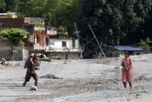 epa13194332 Flood survivors return to home following a flash flood in Devighat Village, Nuwakot district, Nepal, 27 August 2026. More than 160 people have died and hundreds remain missing across northern Nepal after a suspected avalanche triggered massive flash floods and mudslides along the Bhotekoshi and Trishuli river near the Nepal-Tibet border, causing...