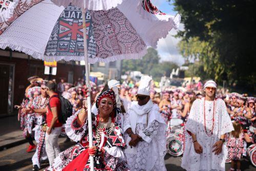 epa13202242 Costumed participants perform during the Notting Hill Carnival adults' parade in London, Britain, 31 August 2026. The carnival, marking its 60th year, is Europe's largest street carnival, celebrating Caribbean history and culture, and runs from 30 August to 31 August 2026.  EPA/TOLGA AKMEN