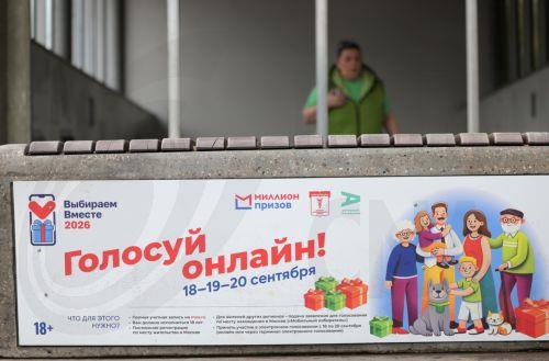 epa13202301 A woman walks next to a billboard announcing the upcoming parliamentary elections in Moscow, Russia, 31 August 2026. Parliamentary elections in Russia are scheduled for 18 to 20 September 2026.  EPA/MAXIM SHIPENKOV