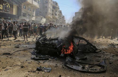 epa13202348 Palestinians inspect a destroyed car following an Israeli air strike on Gaza City, 31 August 2026. According to reports by the Ministry of Health in Gaza, at least three Palestinians were killed in the Israeli attack.  EPA/MOHAMMED SABER