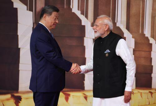 epa13233827 Chinese President Xi Jinping (L) is welcomed by Indian Prime Minister Narendra Modi during an official welcome ceremony for leaders of BRICS member states in New Delhi, India, 12 September 2026. India hosts the 18th BRICS Leaders' Summit from 12 to 13 September 2026 under the theme 'Building for Resilience, Innovation, Cooperation and...