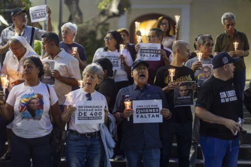 epa13238096 People hold signs and lit candles at a vigil to pray for the release of political prisoners in Caracas, Venezuela, 13 September 2026.  EPA/MIGUEL GUTIERREZ