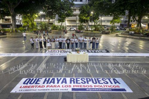 epa13238099 People hold signs and lit candles at a vigil to pray for the release of political prisoners in Caracas, Venezuela, 13 September 2026.  EPA/MIGUEL GUTIERREZ