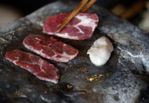 epa13238470 Bear meat is cooked on a stone at Suzukaen, a restaurant serving gibier meat in Chichibu, Saitama prefecture, northeast of Tokyo, Japan, 09 September 2026 (issued 14 September 2026). Suzukaen, a restaurant specializing in game meat, is one of the few establishments in Japan to feature bear on its menu, amid unprecedented rise in bear attacks. ...