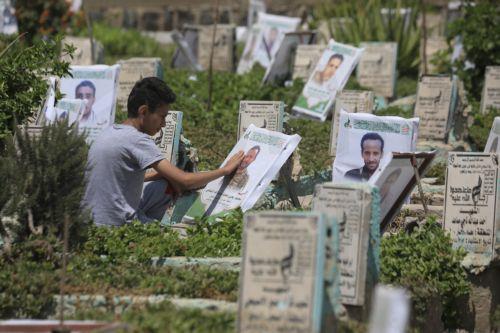 epa13277436 A person cleans the portrait on the grave of a relative at a cemetery dedicated to those who were killed in Yemen's prolonged conflict, in Sana'a, Yemen, 02 October 2026. Yemen has been at risk of rupture again amid escalating fighting along the country’s Red Sea coastal areas near the Bab al-Mandeb Strait between Saudi-backed government forces...