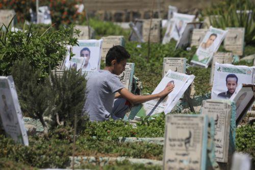 epa13277438 A person cleans the portrait on the grave of a relative at a cemetery dedicated to those who were killed in Yemen's prolonged conflict, in Sana'a, Yemen, 02 October 2026. Yemen has been at risk of rupture again amid escalating fighting along the country’s Red Sea coastal areas near the Bab al-Mandeb Strait between Saudi-backed government forces...