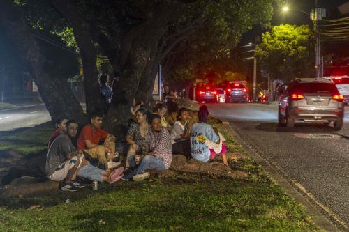 epa13293164 People wait on an avenue after a magnitude 7.7 earthquake struck southeastern Panama, in Panama City, Panama, 9 October 2026. The Geosciences Institute (IGC) reported that more than a hundred aftershocks have followed the magnitude 7.5 to 7.7 earthquake that struck the southeast of the country, while civil protection sources report at least two...