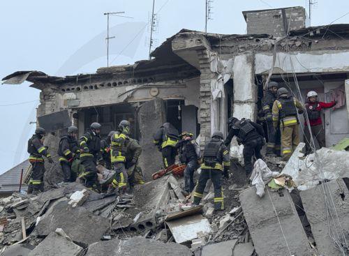 epa13293547 Ukrainian rescuers work at the site of a Russian attack on a residential area in Zaporizhzhia, Ukraine, 10 October 2026, amid the ongoing Russian invasion. At least five people, including two children, were killed and 11 others injured in overnight Russian strikes on the residential area, according to the State Emergency Service.  EPA/DARYNA...