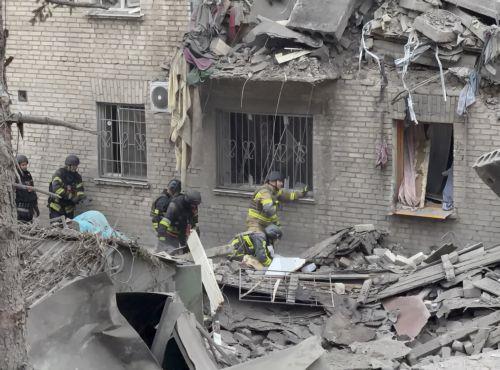 epa13293550 Ukrainian rescuers work at the site of a Russian attack on a residential area in Zaporizhzhia, Ukraine, 10 October 2026, amid the ongoing Russian invasion. At least five people, including two children, were killed and 11 others injured in overnight Russian strikes on the residential area, according to the State Emergency Service.  EPA/DARYNA...