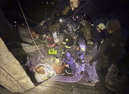 epa13293551 Ukrainian rescuers search for and free people trapped under the rubble at the site of a Russian attack on a residential area in Zaporizhzhia, Ukraine, 10 October 2026, amid the ongoing Russian invasion. At least five people, including two children, were killed and 11 others injured in overnight Russian strikes on the residential area, according...