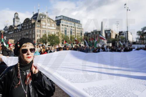 epa13296360 Demonstrators participate in a national protest in support of the Palestinian people on Dam Square in Amsterdam, the Netherlands, marking the conclusion of a nationwide week of action calling for sanctions against Israel, 11 October 2026. According to various activist groups, despite the 'ceasefire', the genocide against the Palestinian people...