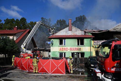 epa13309165 Firefighters fight the flames of a warehouse storing agricultural tractors in Nisko, southeastern Poland, 16 October 2026. Two firefighters were killed while fighting a fire at a warehouse storing agricultural tractor parts in Nisko. The fire broke out at around 8am, and efforts to bring it under control are still ongoing.  EPA/Darek Delmanowicz...