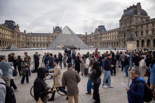epa13315299 Visitors wait outside as protesters block the entrance to the Louvre Museum to express their 'support' for the high school students' movement in Paris, France, 19 October 2026, two days after demonstrations and riots took place alongside nationwide cost-of-living protests.  EPA/CHRISTOPHE PETIT TESSON