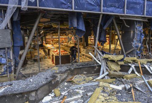epa13315405 A pereson inspects the site of a Russian missile strike on a shopping mall in Kyiv, Ukraine, 19 October 2026, amid the ongoing Russian invasion. At least one person was killed, and 10 others were injured in strikes across the region, including three children, according to the State Emergency Service.  EPA/MAXYM MARUSENKO