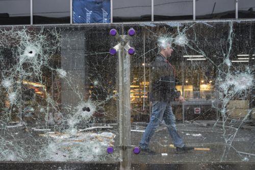epa13315409 A person walks past the site of a Russian missile strike on a shopping mall in Kyiv, Ukraine, 19 October 2026, amid the ongoing Russian invasion. At least one person was killed, and 10 others were injured in strikes across the region, including three children, according to the State Emergency Service.  EPA/MAXYM MARUSENKO