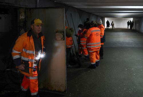 epa13315410 People take shelter in an underground passage during an air raid alert at the site of a Russian missile strike on a shopping mall in Kyiv, Ukraine, 19 October 2026, amid the ongoing Russian invasion. At least one person was killed, and 10 others were injured in strikes across the region, including three children, according to the State Emergency...