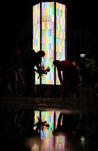 epa13323686 People ‘photograph Colour Rush’ by British artist Liz West during 'River of Light,' an illuminated outdoor art trail in Liverpool, Britain, 22 October 2026. The exhibition trail features 13 large-scale light installations based on the theme ’Together', with installations focusing on how light can bring people closer together. The installations...