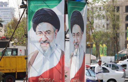 epa13336134 An Iranian traffic police officer stands next to billboards featuring Iran’s Supreme Leader Ayatollah Mojtaba Khamenei on a street in Tehran, Iran, 28 October 2026, amid the ongoing US-Iran conflict.  EPA/ABEDIN TAHERKENAREH RESTRICTIONS: NO Access Israel Media/Persian Language TV Stations Outside Iran/Strictly No Access BBC Persian/VOA...