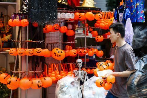 epa13340464 A man sells Halloween decorations and costumes at a shop in Hanoi, Vietnam, 30 October 2026. Halloween is celebrated annually on 31 October and has gained increasing popularity among younger generations in Vietnam.  EPA/LUONG THAI LINH