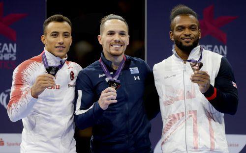 epa10131860 Gold medalist Eleftherios Petrounias (C) of Greece, silver medalist Adem Asil (L) of Turkey and bronze medalist Courtney Tulloch of Great Britain during the medal ceremony for the men's final on the Rings during the Artistic Gymnastics events at the European Championships Munich 2022, Munich, Germany, 21 August 2022. The championships will...