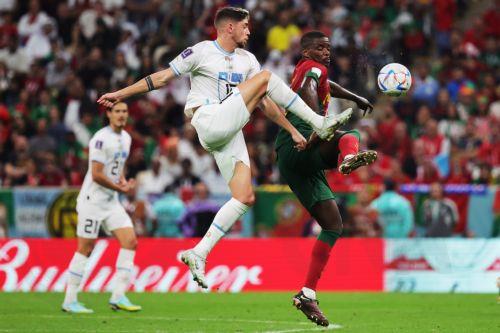 epa10335424 William Carvalho (R) of Portugal in action against Federico Valverde of Uruguay  during the FIFA World Cup 2022 group H soccer match between Portugal and Uruguay at Lusail Stadium in Lusail, Qatar, 28 November 2022.  EPA/Abir Sultan