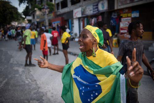epa10335554 Groups of Haitian citizens celebrate Brazil's victory over Switzerland during the World Cup match, in Port-au-Prince, Haiti, 28 November 2022. Haitians follow the Qatar 2022 World Cup games, especially those of the Brazilian and Argentine teams, which serves as a distraction as the country is experiencing one of its worst political crises, gang...