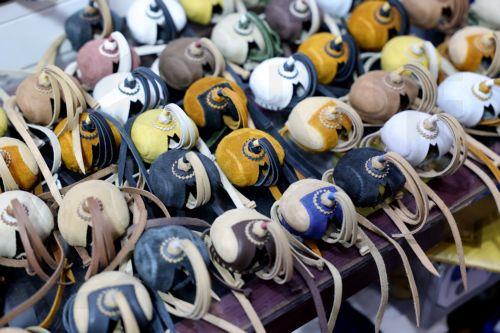 epa10348416 Falcons head covers on display at the Falcon market in Souq Waqif, an old marketplace in Doha, Qatar, 04 December 2022. The falcon is the national bird of Qatar and part of the culture of the Qatari people. The Falcon market in Souq Waqif offers special accessories and falcons sales and play as  one of the major tourists attractions of the...