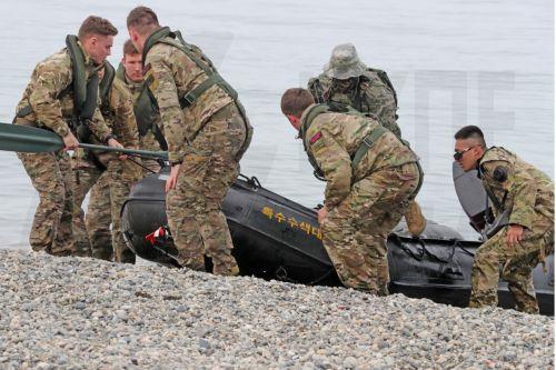 epa10537823 South Korean and British Marines land by a combat rubber raiding craft during combined airborne and maritime infiltration drills with US troops in Pohang, South Korea, 22 March 2023 (issued 23 March 2023). The two-day drills, which will run through the following day, are part of the ongoing South Korea-US Sangyong amphibious landing exercise...