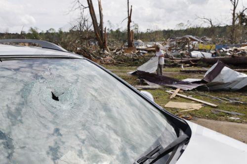 epa10546226 Kyle Williams picks up debris in the wake of a tornado in West Point, Georgia, USA, 27 March 2023. Tornadoes were confirmed in Georgia on 26 March two days after at least 25 people were killed in Mississippi after a tornado and severe weather outbreak on 24 March, according to the Mississippi Emergency Management Agency.  EPA/ERIK S. LESSER