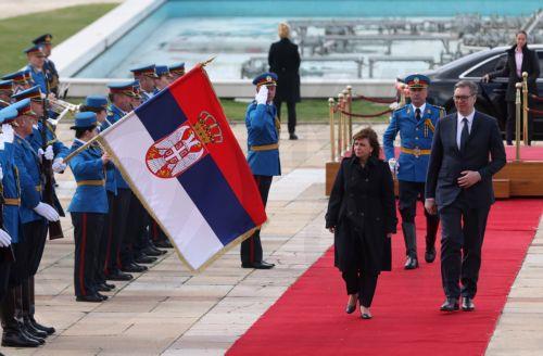 epa10546704 Serbian President Aleksandar Vucic (R) and Greek President Katerina Sakellaropoulou (L) inspect the honor guards ahead of their meeting in Belgrade, Serbia, 28 March 2023. President Sakellaropoulou is on an official visit to Serbia.  EPA/ANDREJ CUKIC